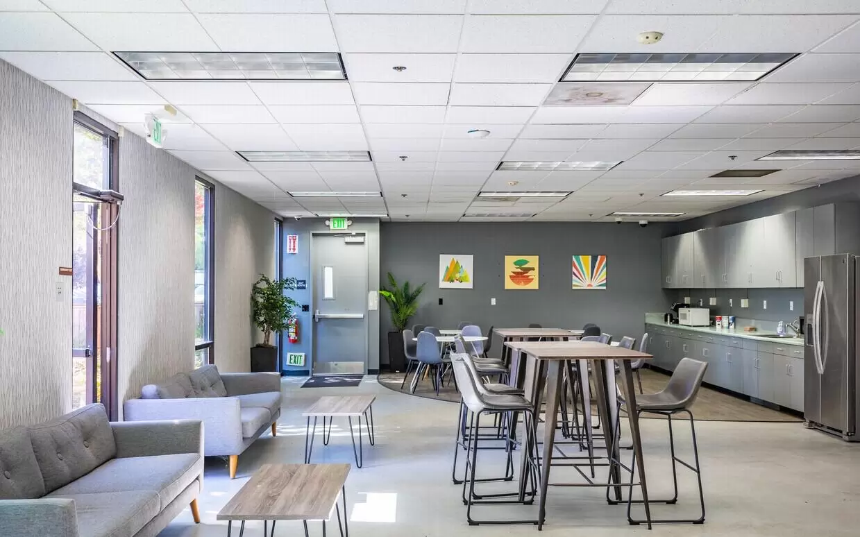 A modern coworking space with couches and tables in Santa Clara, CA