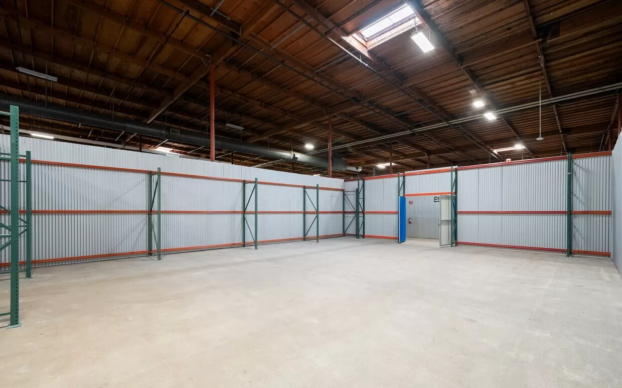 A large warehouse in Hayward with shelves and a ceiling available for rent.