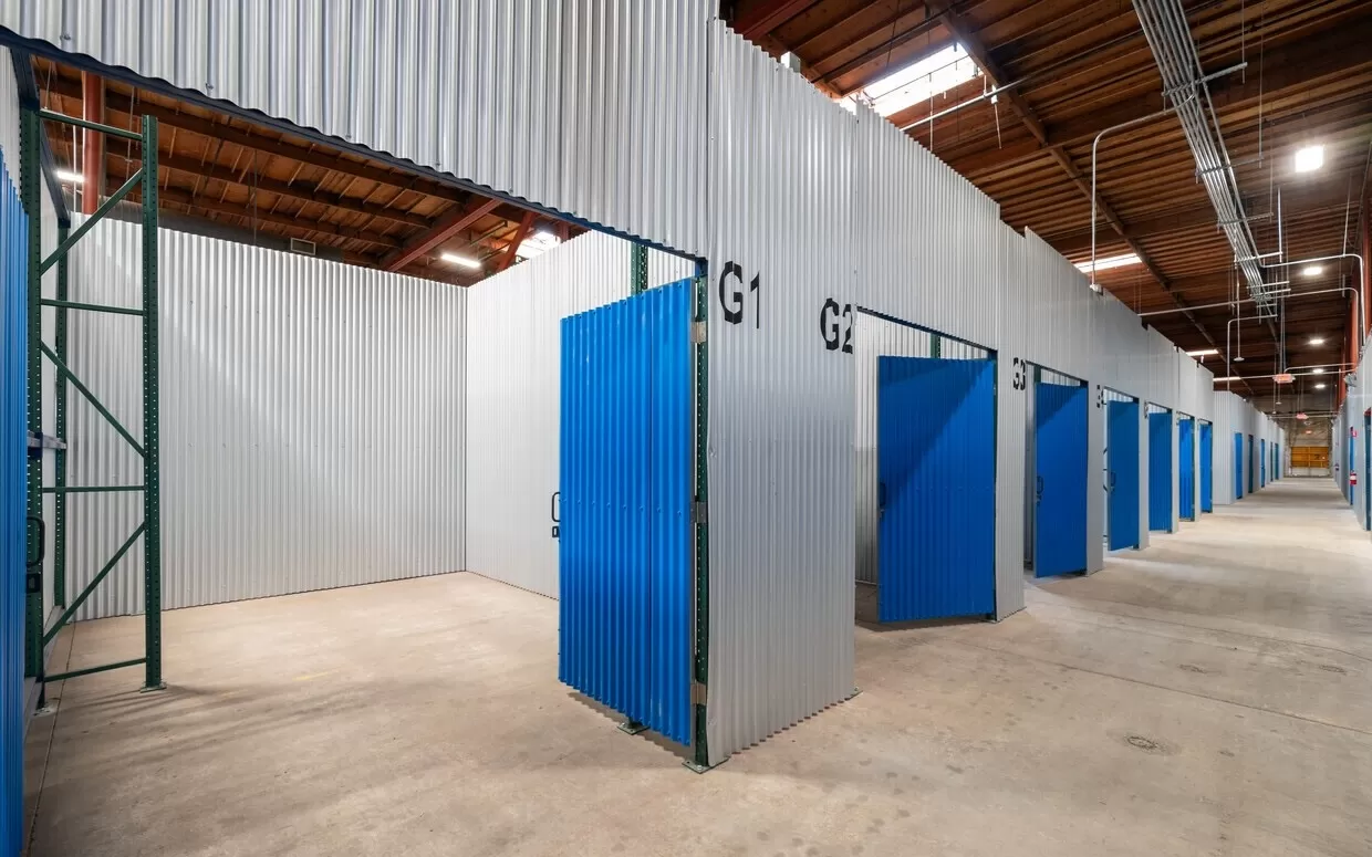A spacious warehouse in Hayward with large blue doors, ideal for storage.
