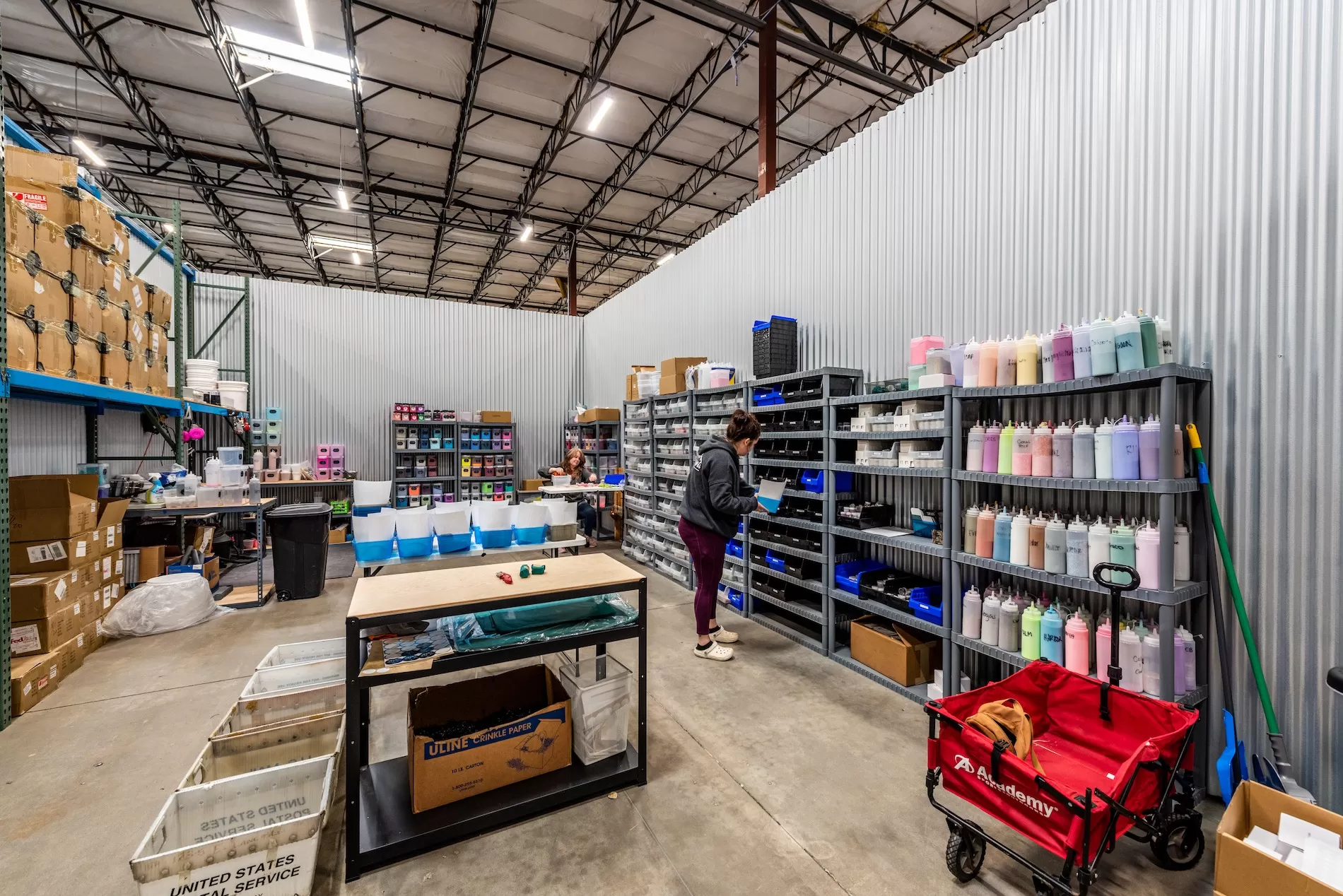 The inside of a large warehouse with shelves and boxes.