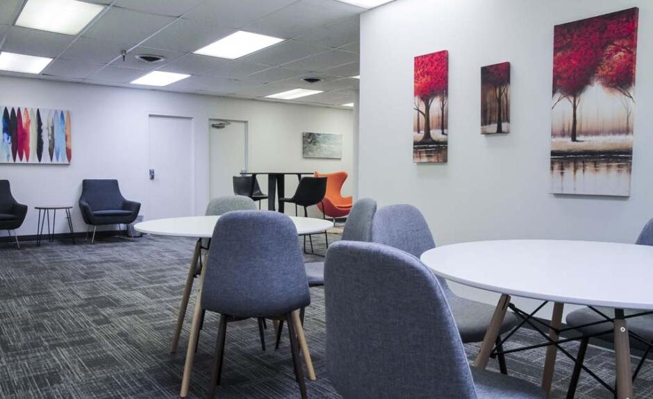 A conference room with a table and chairs.