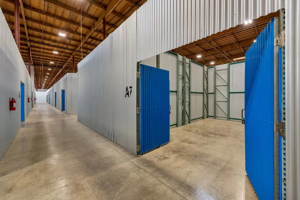 A large storage facility with blue doors.