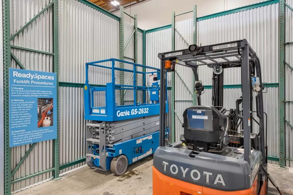 A toyota forklift is parked in a warehouse.