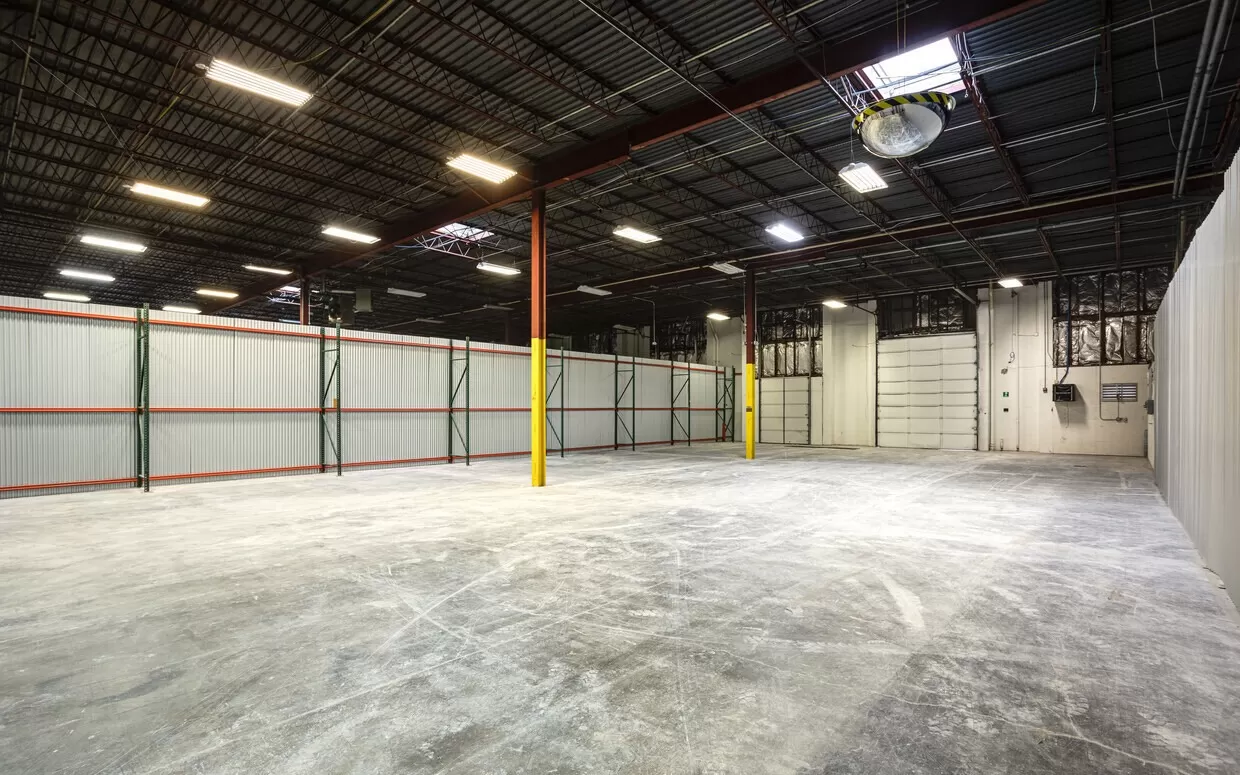 A large warehouse with a concrete floor.