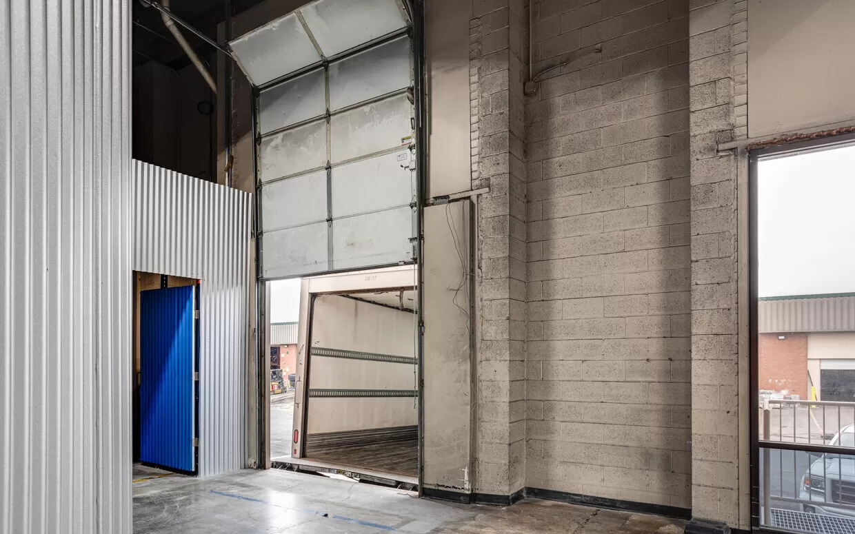 An empty warehouse with a door and a blue door in Landover.