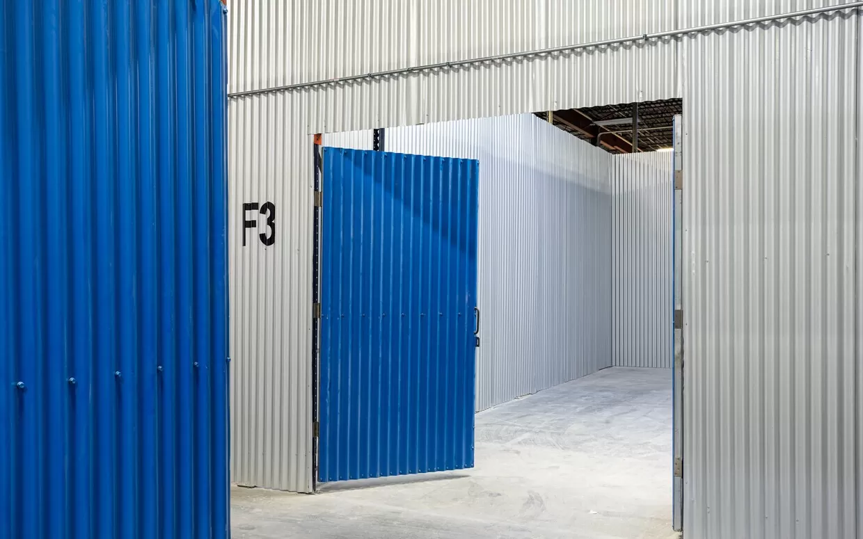 The entrance to a storage room with blue doors.