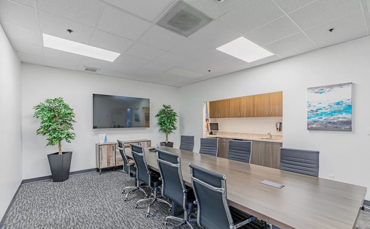 A conference room with a large table and chairs in Chula Vista, CA.